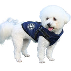 White dog wearing a navy blue jacket with a logo on a white background