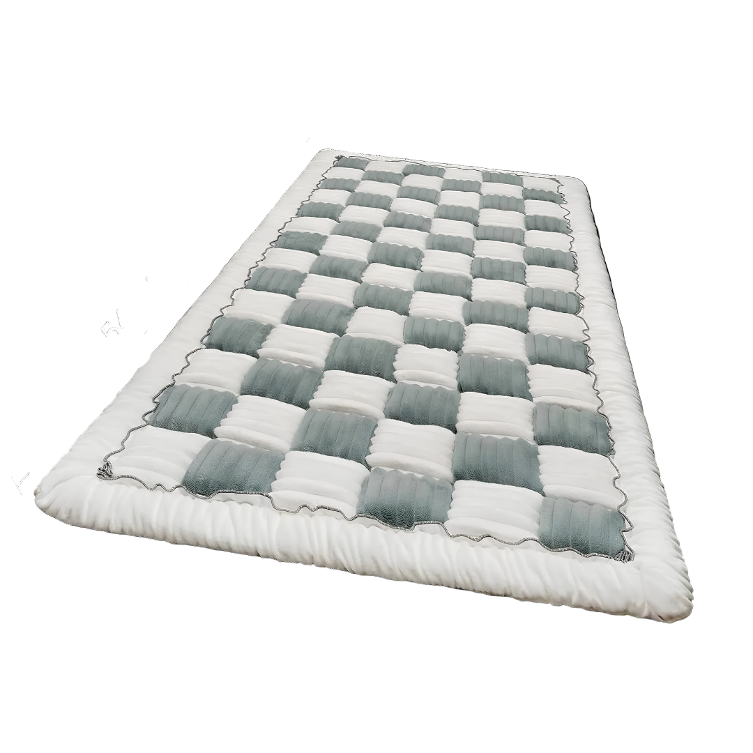 Checkered quilt with white and gray squares on a white background